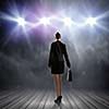 Rear view of businesswoman standing in lights of stage