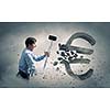 Young businessman crashing with hammer stone euro symbol