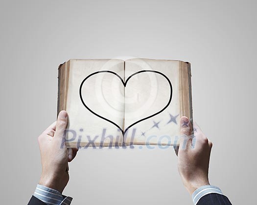 Close up of male hands holding opened book Close up of male hands holding opened book