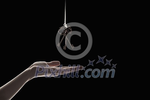 Close up of woman hand holding golden key Close up of woman hand holding golden key