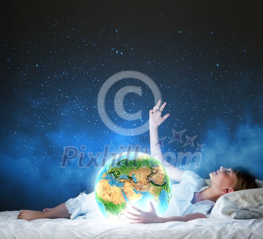 Cute girl sleeping in bed and looking at Earth planet. Elements of this image are furnished by NASA Cute girl sleeping in bed and looking at Earth planet. Elements of this image are furnished by NASA