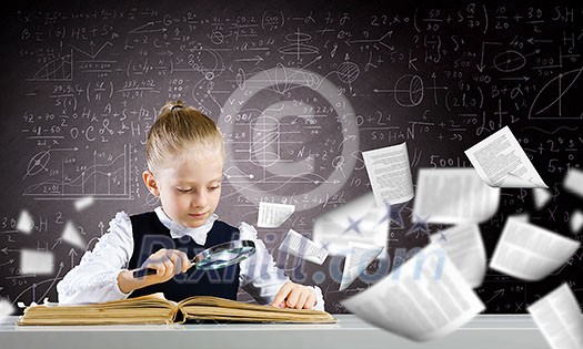 Schoolgirl examining opened book with magnifying glass Schoolgirl examining opened book with magnifying glass
