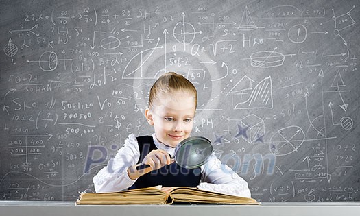 Schoolgirl examining opened book with magnifying glass Schoolgirl examining opened book with magnifying glass