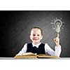 Schoolgirl at lesson with opened book against sketch background