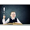 Schoolgirl at lesson with opened book against sketch background