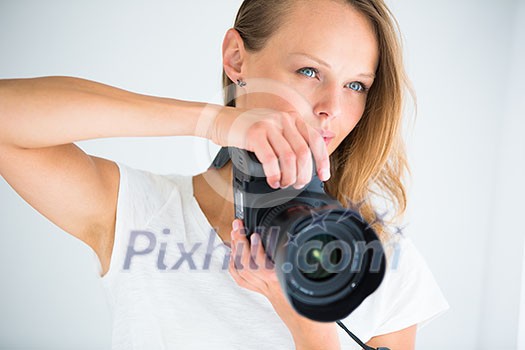 Pretty, female photographer with digital camera - DSLR (color toned image; shallow DOF) Pretty, female photographer with digital camera - DSLR (color toned image; shallow DOF)