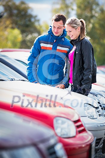 Young couple choosing the right car for them Young couple choosing the right car for them