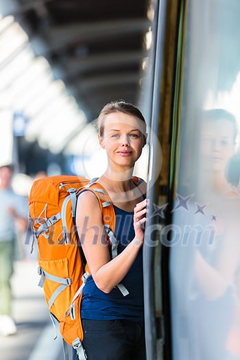 Pretty, young woman in a trainstation, waiting for her train, boarding a train (color toned image) Pretty, young woman in a trainstation, waiting for her train, boarding a train (color toned image)
