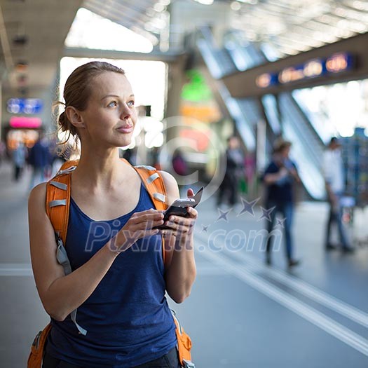 Pretty, young woman in a trainstation, waiting for her train, boarding a train (color toned image) Pretty, young woman in a trainstation, waiting for her train, boarding a train (color toned image)