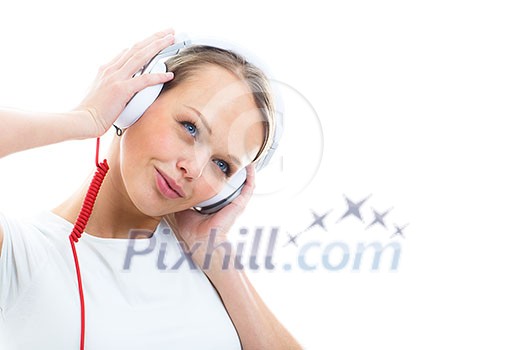 Pretty, young woman listening to her favorite music on hi-fi headphones, dancing, enjoying the tune, having a moment for herself Pretty, young woman listening to her favorite music on hi-fi headphones, dancing, enjoying the tune, having a moment for herself