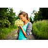 Young woman picking elderflower to make an infusion at home