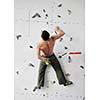 young and fit man exercise free mountain climbing on indoor practice wall