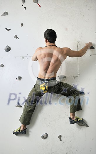 young and fit man exercise free mountain climbing on indoor practice wall young and fit man exercise free mountain climbing on indoor practice wall