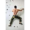 young and fit man exercise free mountain climbing on indoor practice wall