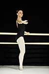 young happy ballet girl ballerina perform dance on stage at ballet school class