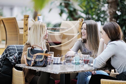 very cute smiling women drinking a coffee sitting inside in cafe restaurant very cute smiling women drinking a coffee sitting inside in cafe restaurant