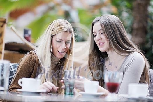 very cute smiling women drinking a coffee sitting inside in cafe restaurant very cute smiling women drinking a coffee sitting inside in cafe restaurant