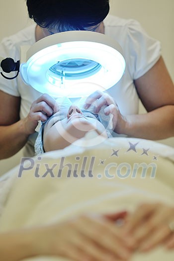 Young beautiful woman receiving cosmetic facial mask in spa beauty salon and relax Young beautiful woman receiving cosmetic facial mask in spa beauty salon and relax