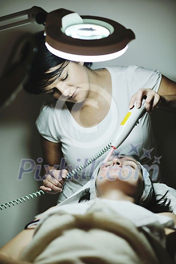 Young beautiful woman receiving cosmetic facial mask in spa beauty salon and relax Young beautiful woman receiving cosmetic facial mask in spa beauty salon and relax