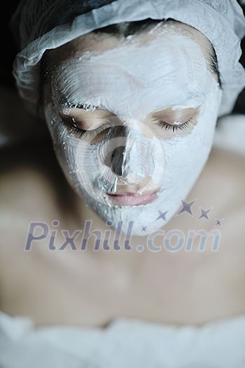 Young beautiful woman receiving cosmetic facial mask in spa beauty salon and relax Young beautiful woman receiving cosmetic facial mask in spa beauty salon and relax