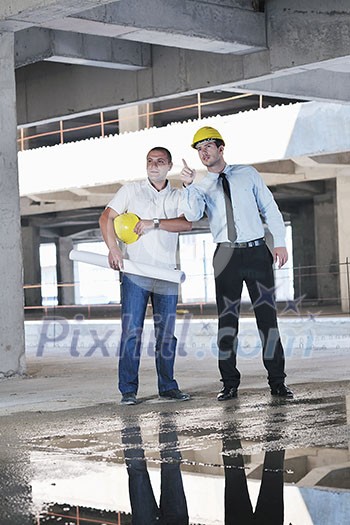 Team of business people in group, architect and engeneer  on construciton site check documents and business workflow on new building