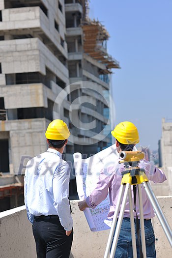 Team of architects people in group on construciton site check documents and business workflow Team of architects people in group on construciton site check documents and business workflow