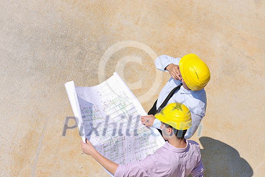 Team of architects people in group on construciton site check documents and business workflow Team of architects people in group on construciton site check documents and business workflow