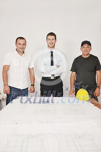 Team of architects people in group on construciton site check documents and business workflow Team of architects people in group on construciton site check documents and business workflow
