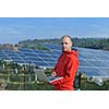 business man  engineer using laptop at solar panels plant eco energy field  in background