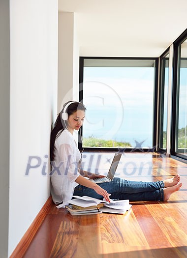 beautiful young woman relax and work on laptop computer while working on laptop computer and read book at home beautiful young woman relax and work on laptop computer while working on laptop computer and read book at home