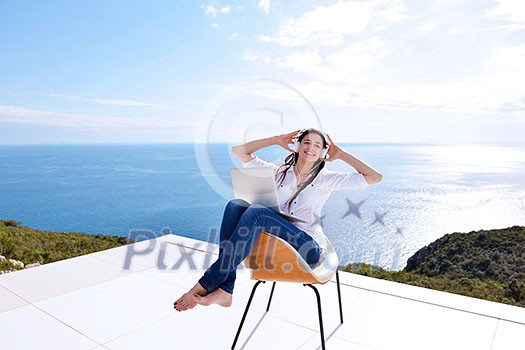 beautiful young woman relax and work on laptop computer while working on laptop computer and read book at home beautiful young woman relax and work on laptop computer while working on laptop computer and read book at home