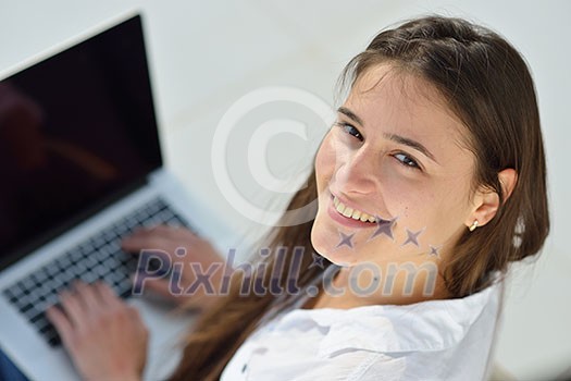 beautiful young woman relax and work on laptop computer modern  home office