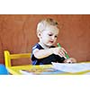 happy little child play game and have fun, education lessons in colorful kinder garden playground indoors