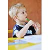 happy little child play game and have fun, education lessons in colorful kinder garden playground indoors