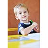 happy little child play game and have fun, education lessons in colorful kinder garden playground indoors