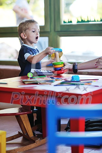 happy little child play game and have fun, education lessons in colorful kinder garden playground indoors happy little child play game and have fun, education lessons in colorful kinder garden playground indoors