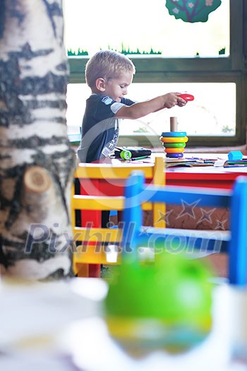 happy little child play game and have fun, education lessons in colorful kinder garden playground indoors happy little child play game and have fun, education lessons in colorful kinder garden playground indoors