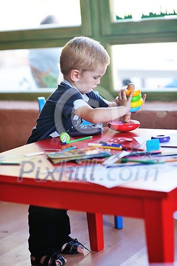 happy little child play game and have fun, education lessons in colorful kinder garden playground indoors happy little child play game and have fun, education lessons in colorful kinder garden playground indoors