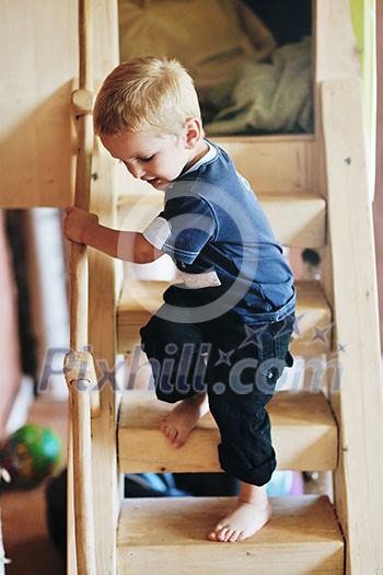 beautiful young child making first steps and have fun in play ground beautiful young child making first steps and have fun in play ground