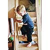 beautiful young child making first steps  and have fun in play ground