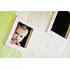 happy cute child in a wooden window at playground