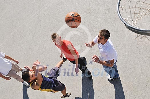 gorup of young boys who playing basketball outdoor on street with long shadows and bird view perspective gorup of young boys who playing basketball outdoor on street with long shadows and bird view perspective