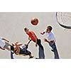 gorup of young boys who playing basketball outdoor on street with long shadows and bird view perspective