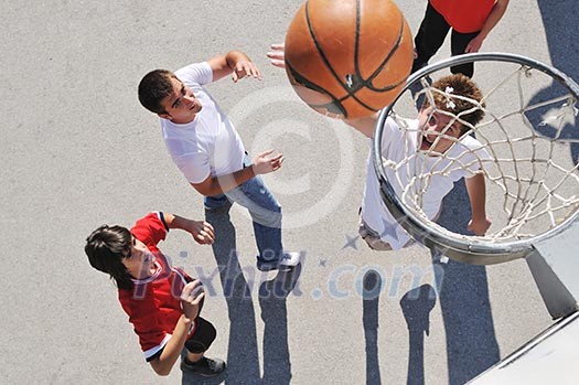 gorup of young boys who playing basketball outdoor on street with long shadows and bird view perspective gorup of young boys who playing basketball outdoor on street with long shadows and bird view perspective