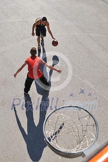 gorup of young boys who playing basketball outdoor on street with long shadows and bird view perspective gorup of young boys who playing basketball outdoor on street with long shadows and bird view perspective