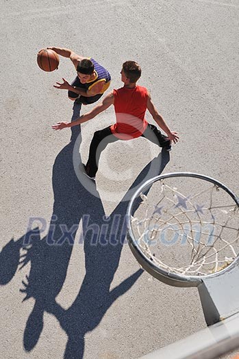 gorup of young boys who playing basketball outdoor on street with long shadows and bird view perspective gorup of young boys who playing basketball outdoor on street with long shadows and bird view perspective
