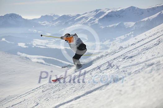skier free ride downhill at winter season on beautiful sunny day skier free ride downhill at winter season on beautiful sunny day