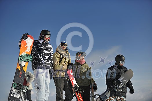 young snowboarders group have fun and relax at sunny winter day on winter season young snowboarders group have fun and relax at sunny winter day on winter season