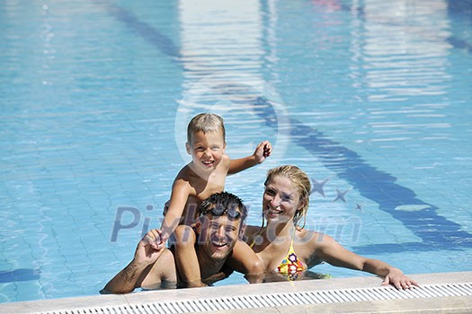 happy young family have fun on swimming pool at summer vacation happy young family have fun on swimming pool at summer vacation