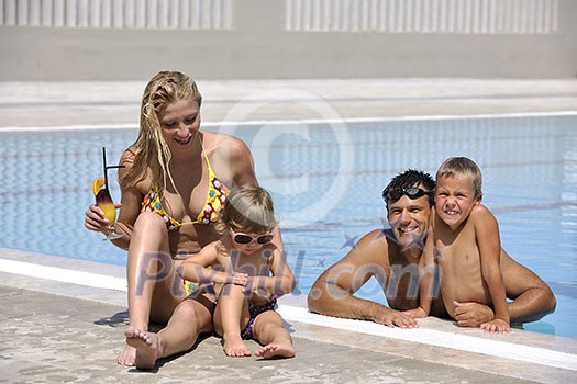 happy young family have fun on swimming pool at summer vacation happy young family have fun on swimming pool at summer vacation